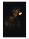 A Miner with a Head Lamp Works Inside the Csa Coal Mine at Karvina by James P. Blair